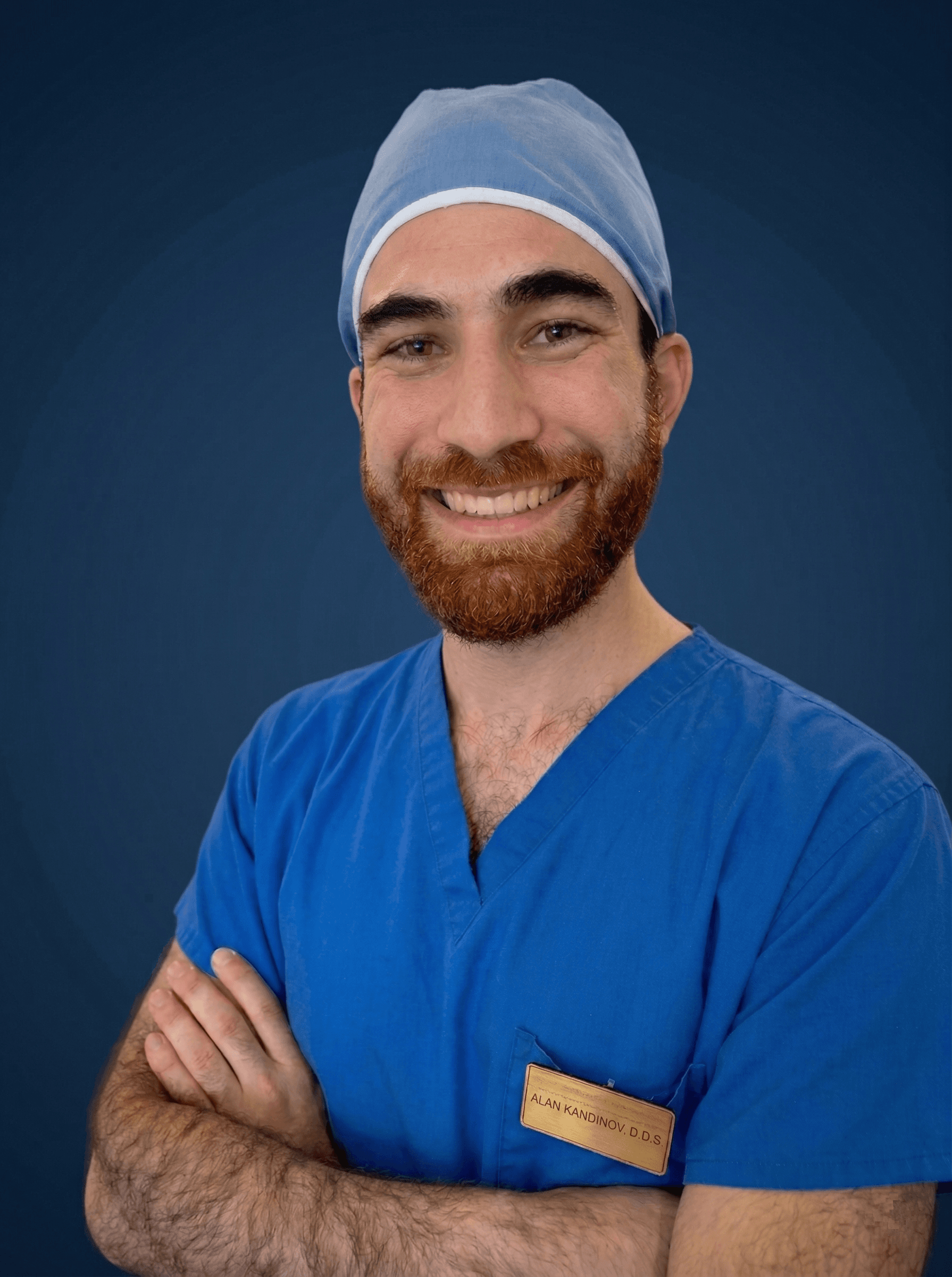 Dr. Alan smiling in blue scrubs